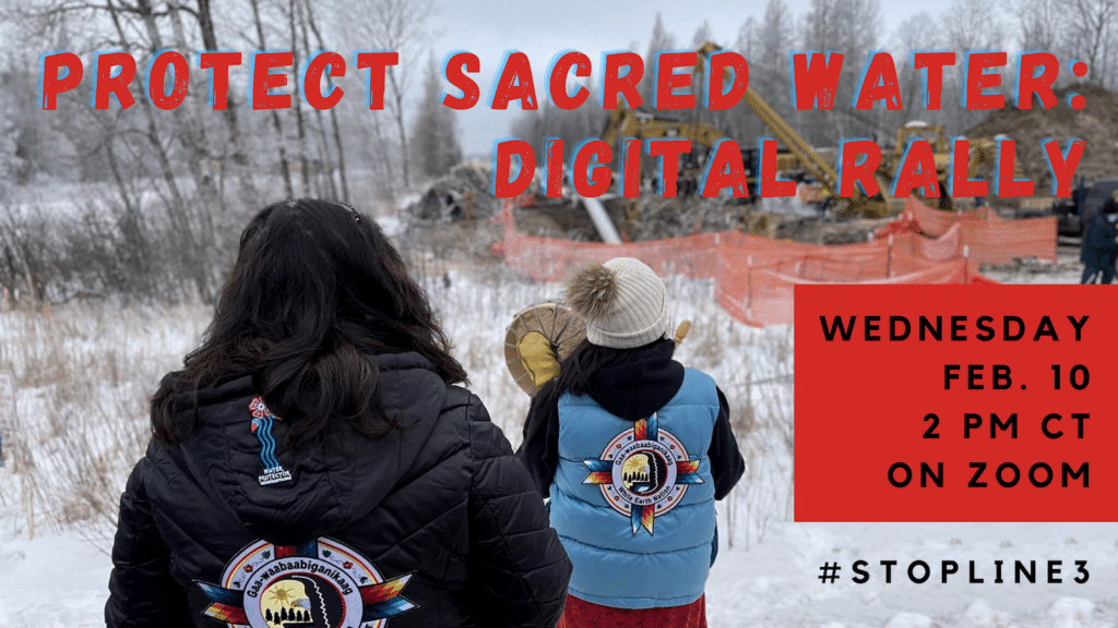 2 Indigenous women are in the foreground with their backs to the camera. They are looking out into the near distance of bulldozers and other equipment constructing the Line 3 pipeline.