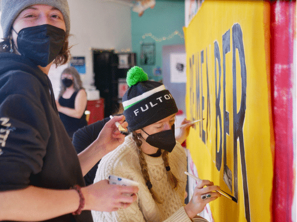 artists at work creating a sign