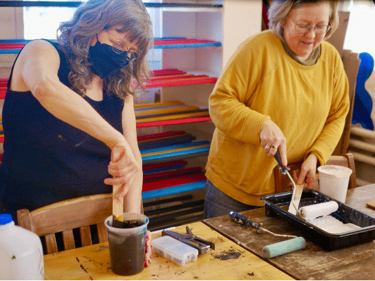 Artists at work painting signs